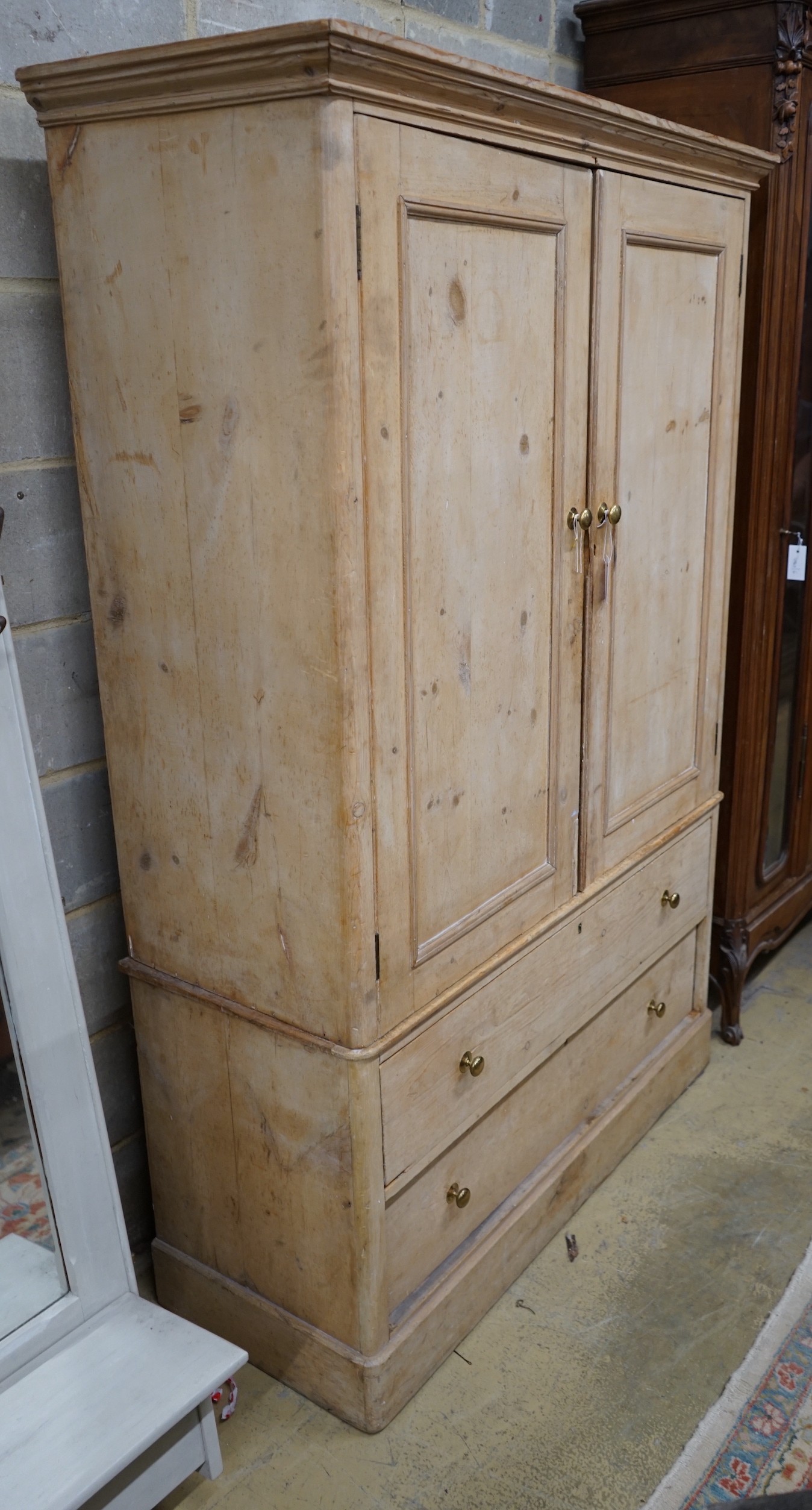 A Victorian pine two drawer hanging cupboard, width 123cm, depth 48cm, height 183cm